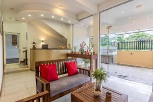 a living room with a couch and red pillows at Fisherman's Cove in Wattala