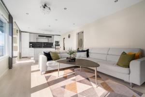 a living room with a couch and a table at Panorama view! Modern,Balcony/parking in Bodø