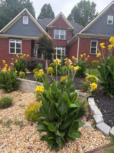 a house with flowers in the front yard at Karibuni Braselton in Braselton