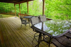 a screened porch with a table and chairs on it at Moonbeam Chalet in Logan