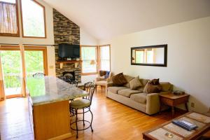 a living room with a couch and a table at Moonbeam Chalet in Logan