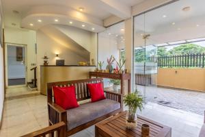 a living room with a couch and red pillows at Fisherman's Cove in Wattala +36 photos