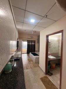 a bathroom with a tub and a sink and a mirror at Skyline suites in Greater Noida