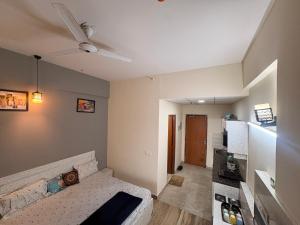 a living room with a couch and a ceiling fan at Skyline suites in Greater Noida +4 photos