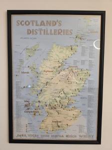 a map of scotlands distillers hanging on a wall at Single Malt Apartment in the old distillery in Inverlochy