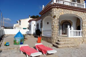 a building with two picnic tables and a playground at Meddays Villa Zaragoza in Miami Platja