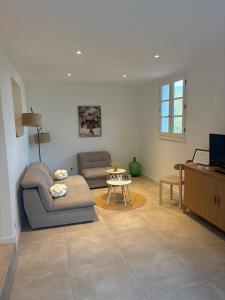 a living room with a couch and a table at Appartement Bastia Cardo Village in Bastia