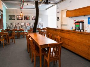 a dining room with wooden tables and chairs at Mango Tree Ipanema in Rio de Janeiro