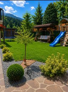 a yard with a playground and a slide at Pensiunea Alex in Borsa
