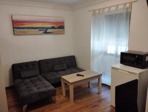 a living room with a couch and a coffee table at APARTAMENTOS POBRA-CASTELO in A Pobra do Caramiñal