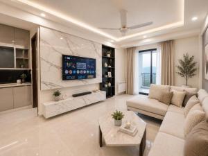 a living room with a couch and a tv at LMY Boutique Prestige Hotel Apartments - Murree Monal Expressway in Murree