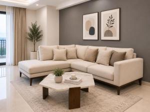 a living room with a white couch and a table at LMY Boutique Prestige Hotel Apartments - Murree Monal Expressway in Murree