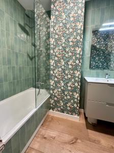 a bathroom with a shower and a tub and a sink at Alegría 2 in Amés