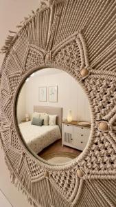 a mirror reflecting a bedroom with a bed in a room at Alegría 2 in Amés