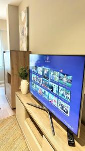 a large flat screen tv sitting on top of a table at Alegría 2 in Amés