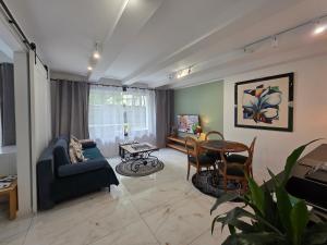 a living room with a couch and a table at Apartamenty Biała Perła in Ustroń