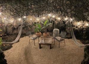 a room with chairs and a table and lights at Glamping en Casa Viento in Tepoztlán +8 photos