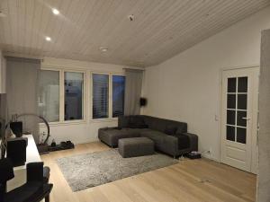 a living room with a couch and a table at Villa Herttala in Jyväskylä