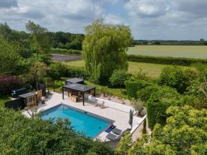 an overhead view of a swimming pool in a garden at Serenity Villa in Beccles