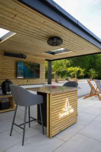 an outdoor bar with two chairs and a table at Serenity Villa in Beccles +16 photos