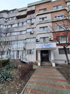 a building with a brick path in front of it at Relax Apartament in Constanţa