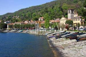 a bunch of boats are lined up on a river at Casa Renoir appartamento a due passi dal lago in Verbania +16 photos
