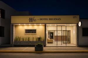 a store front of a hotel heinemann building at night at Ayenda Hotel Helenas in Ríohacha
