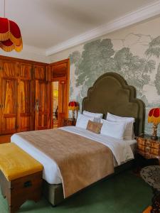 a bedroom with a large bed and a wall with a map at Casa do Fontão in Amarante +147 photos