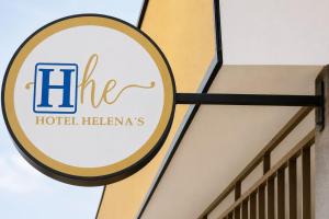 a sign for a hotel heinemann building at Ayenda Hotel Helenas in Ríohacha