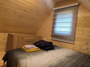 a room with a bed and a window in a cabin at Apartmani Slavko in Konjska Reka