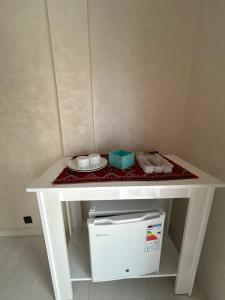 a white table with a plate of food on it at Chez Bouchra suite Royal in Pont Blondin