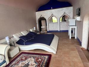 a large bedroom with a large bed and a mirror at Chez Bouchra suite Royal in Pont Blondin