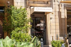 an entrance to a building with a sign on it at Hotel della Piazza in Pizzo +33 photos