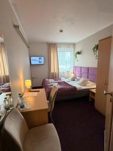 a hotel room with two beds and a desk at Great Polonia Silesian Economy Hotel in Katowice