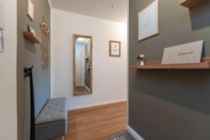a hallway with a mirror and a chair at Haffhafen in Garz +32 photos