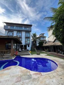 a swimming pool in front of a house at Pousada Pontal RJ in Rio de Janeiro
