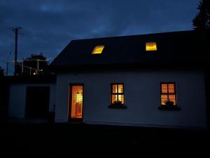 a white house with two windows at night at Five Valleys, Ballinastraw in Bunclody
