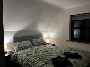 a bedroom with a bed with two bags on it at Five Valleys, Ballinastraw in Bunclody