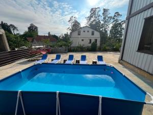 a swimming pool with lounge chairs and a swimming pool at vila in CHAKVI in Chakvi