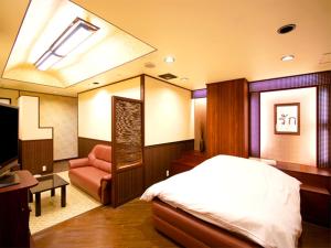A bed or beds in a room at Hotel Joy (Adult Only)