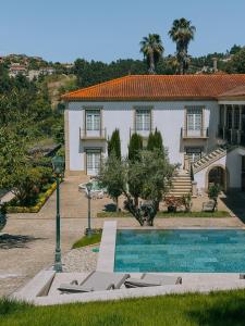 a house with a swimming pool in front of it at Casa do Fontão in Amarante