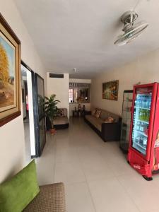 a living room with a coca cola machine at ISIS HOTEl in Tumbes +14 photos