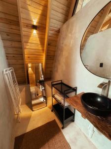 a bathroom with a sink and a mirror at Leisy's Garden Cabins & Dorm in Santa Bárbara de Samaná +79 photos