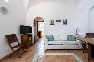 a living room with a couch and a table at Casa Clotilde - nel Cuore di Capri in Capri