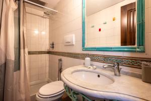 a bathroom with a sink and a toilet and a mirror at Casa Clotilde - nel Cuore di Capri in Capri +40 photos