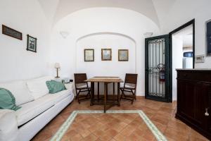 a living room with a couch and a table at Casa Clotilde - nel Cuore di Capri in Capri