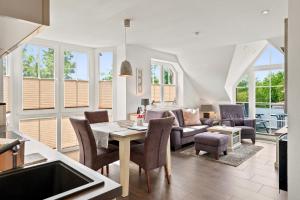 a living room with a table and chairs at Amelie in Greetsiel