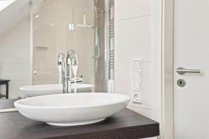 a bathroom with a sink and two sinks in it at Amelie in Greetsiel +20 photos