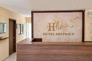 a hotel lobby with a large sign on the wall at Ayenda Hotel Helenas in Ríohacha +72 photos