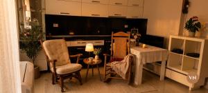 a living room with a table and chairs and a television at Villa Nathanael in Pogradec